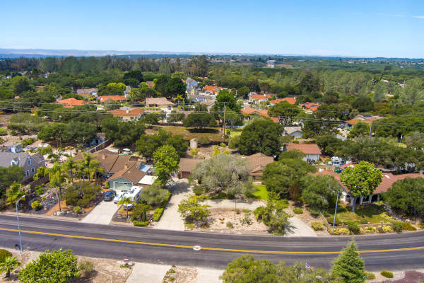 Aerial view of a suburban neighborhood with houses and greenery.