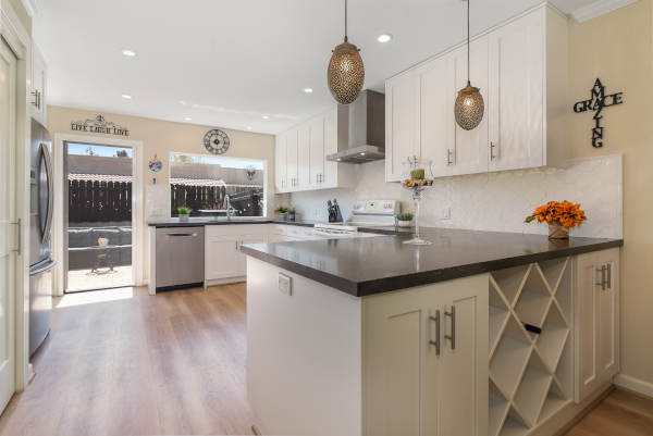 Traditional formal dining room with chandelier lighting and open layout leading into the living room.