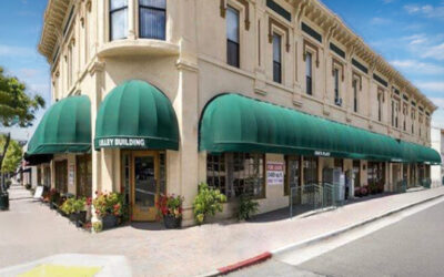 Lompoc Commercial Lily Building Exterior view of the Valley Building featuring green awnings and floral landscaping.