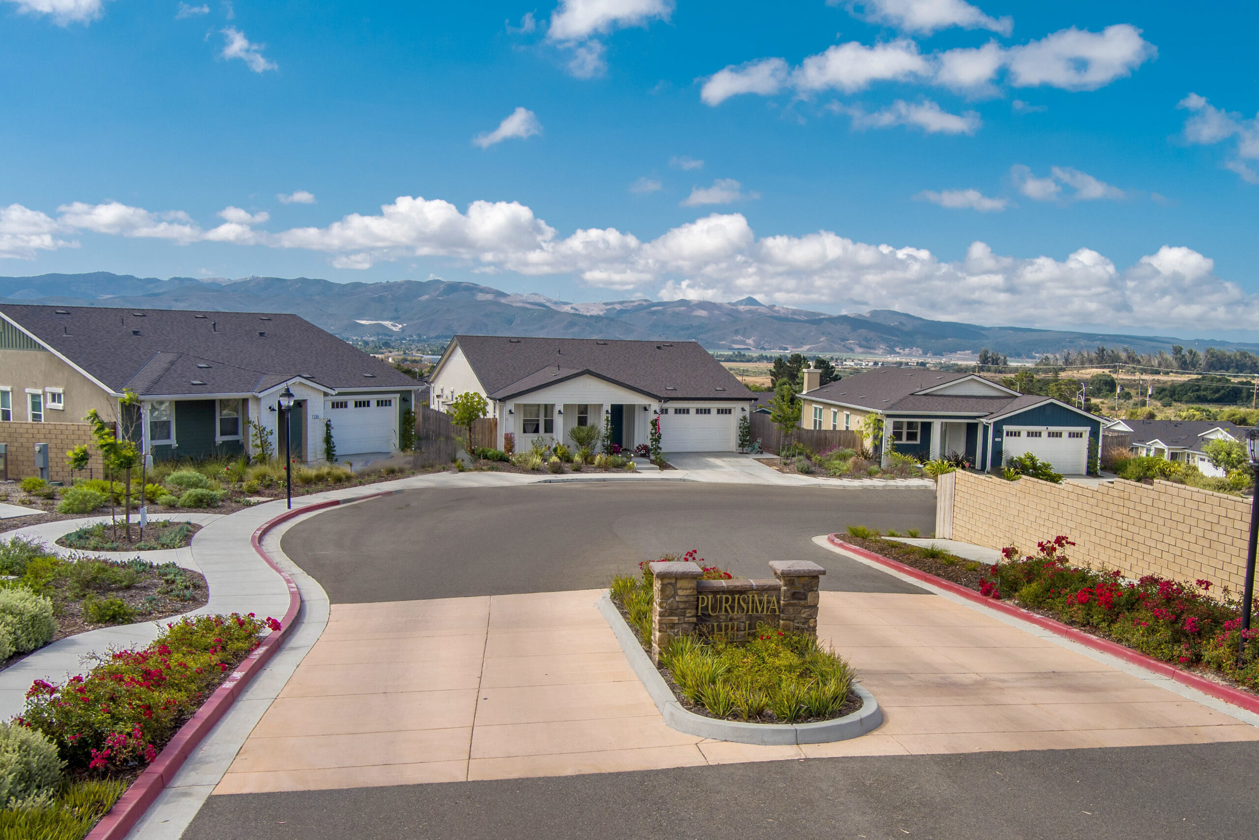 A serene backyard with a pool, dining area, and lush greenery.